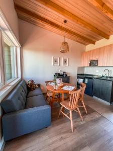 a living room with a couch and a table at Ave Lodge Frutillar in Frutillar +40 photos