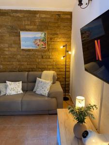 a living room with a couch and a table at Charming Stone Cottage Kotor in Kotor