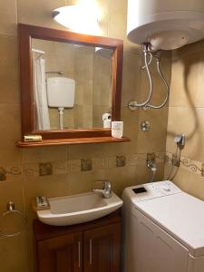 a bathroom with a sink and a mirror at Charming Stone Cottage Kotor in Kotor +19 photos