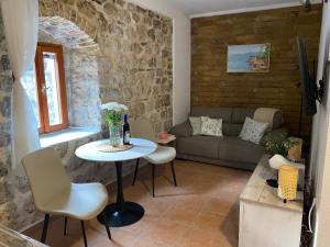 a living room with a table and a couch at Charming Stone Cottage Kotor in Kotor