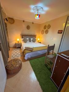 a bedroom with a bed and a green rug at Riad dar sahrawi in Marrakesh +54 photos