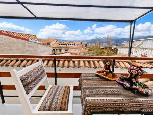 two teddy bears sitting on the balcony of a house at Cusco - Perú "Hotel Boutique Qorikallpa" The true essence of inka culture in Cusco
