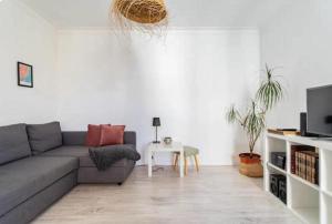 a living room with a couch and a table at Casa da Matilde in Estoril