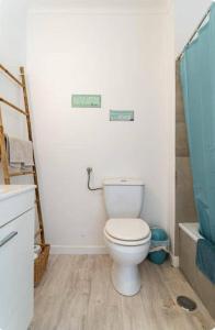 a bathroom with a white toilet and a sink at Casa da Matilde in Estoril