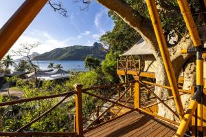 a wooden deck with a view of the water at Barefoot Kuata Island Resort in Kuata