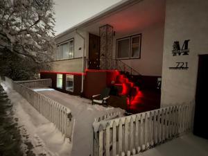 a house with red lights in the snow at Sip and Soak, hotel-style room in Calgary