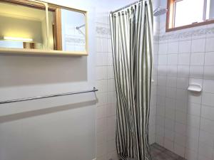 a bathroom with a black and white shower curtain at Dolphin Cove in Wallaroo +13 photos