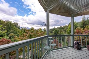 a deck with a view of the woods at Mountain View Paradise by Avada Properties in Gatlinburg +38 photos