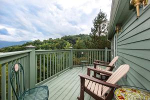 a deck with two chairs and a table on it at Mountain View Paradise by Avada Properties in Gatlinburg