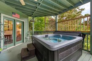 a jacuzzi tub on the back porch of a house at Mountain View Paradise by Avada Properties in Gatlinburg