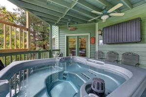 a jacuzzi tub on a screened in porch at Mountain View Paradise by Avada Properties in Gatlinburg