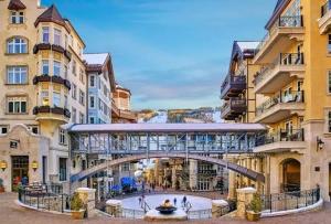 a bridge in the middle of a city with buildings at Treetops Access to Eagle Bahn Gondola in Vail
