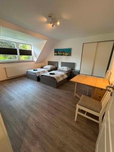 a large room with two beds and a table at Ferienwohnung am Uniklinik in Lübeck
