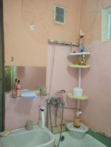 a bathroom with a sink and a pink wall at Квартира in Sumy