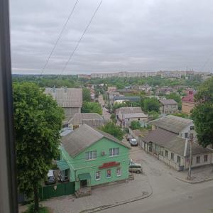 a small town with a green house and a street at Квартира in Sumy