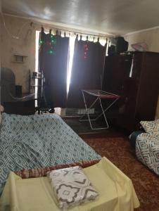 a room with a bed and a table and curtains at Квартира in Sumy