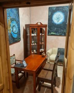 a dining room with a wooden table and chairs at Casa Orígenes Hotel Boutique in Pamplona