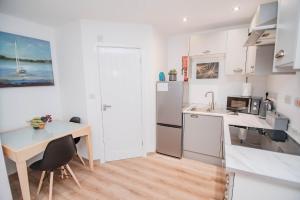 a kitchen with a table and a counter top at City Centre Apt with FREE PARKING in Doncaster