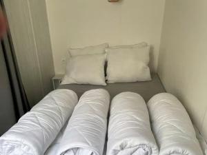a bed in a room with two pillows at Cozy Coco Sweet Glamping Tent for 4 in Rijkevorsel