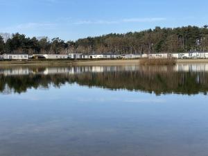 a large body of water with buildings in the background at Cozy Coco Sweet Glamping Tent for 4 in Rijkevorsel