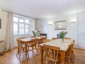 a dining room with wooden tables and chairs at Endeavour - Hhy in Luton