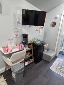 a living room with a table and a television on the wall at Ranch style tiny home retreat Near Downtown Orlando in Orlando