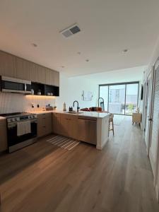 an open kitchen with a sink and a stove at Atl oasis in Atlanta