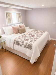 a bedroom with a large white bed with a window at The Bunny Street Getaway! in Kenora