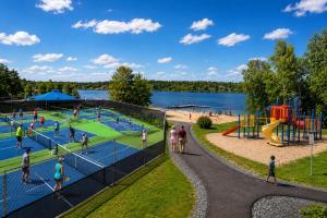 a group of people playing tennis at a playground at The Bunny Street Getaway! in Kenora