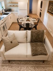 a living room with a white couch and a table at The Bunny Street Getaway! in Kenora +7 photos