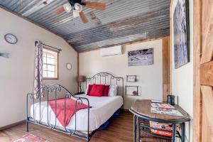 a bedroom with a bed and a wooden ceiling at Hill Country Cabin 4 in Canyon Lake
