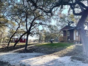 a small house in the middle of a park at Hill Country Cabin 4 in Canyon Lake