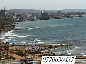 a beach with a lot of people and the ocean at مستغانم حي السلام المجدوب in Sidi Mohammed Medjoub