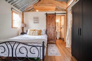 a bedroom with a bed and a wooden ceiling at Hill Country Cabin 1 in Canyon Lake