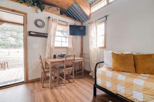 a living room with a table and a couch at Hill Country Cabin 1 in Canyon Lake