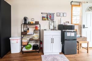a kitchen with a white cabinet and a refrigerator at Hill Country Cabin 1 in Canyon Lake +15 photos