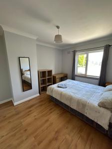 a bedroom with a large bed and a window at Teach Fáilte in Sligo
