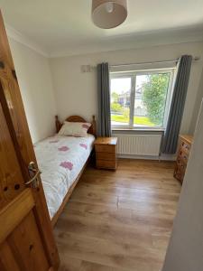 a small bedroom with a bed and a window at Teach Fáilte in Sligo +5 photos