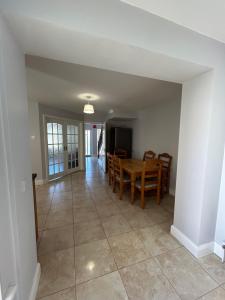 a dining room and living room with a table and chairs at Teach Fáilte in Sligo