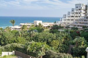 a view of a hotel with the ocean in the background at 43 Sea Lodge - by Stay in Umhlanga in Durban