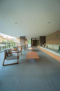 a large room with couches and tables in a building at Loft no Granja Brasil Resort, Itaipava centro, Estrutura Completa in Araras Petropolis