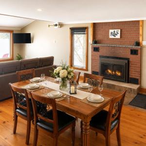 a dining room with a table and a fireplace at Oasis in Ascot Corner