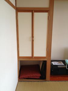a cabinet with two doors in a room at Iyashinoyado Rodem in Morioka
