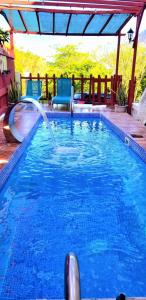 a swimming pool with a water slide in it at Comfort Suites - Studio Two in La Fargue