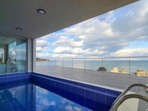 a swimming pool in a house with a view of the ocean at Pohang Horizon Poolvilla in Pohang