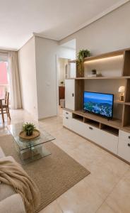 a living room with a flat screen tv at Raffaelas vacation apartment in Torrevieja