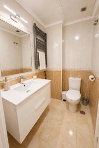 a bathroom with a white sink and a toilet at Raffaelas vacation apartment in Torrevieja