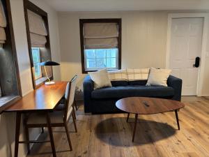 a living room with a couch and a table at Hillside Hotel in Luray