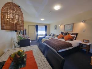 a bedroom with a bed and a couch and a table at #6 Glenorchy Alpine Suite in Glenorchy