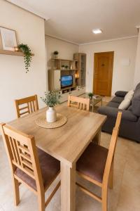 a dining table and chairs in a living room at Raffaelas vacation apartment in Torrevieja